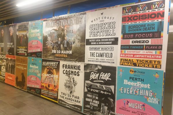 image of various event and street posters mounted on wall