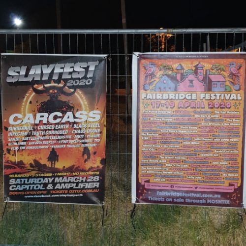 two music event mesh signage banners installed on fence