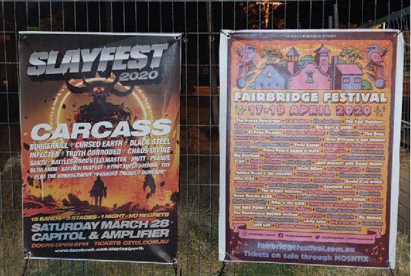 two music event mesh signage banners installed on fence