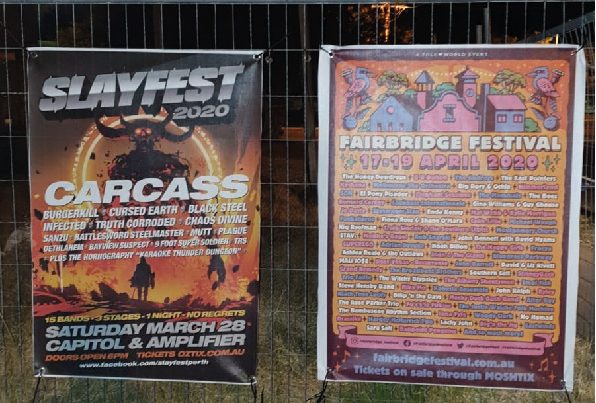 two music event mesh signage banners installed on fence