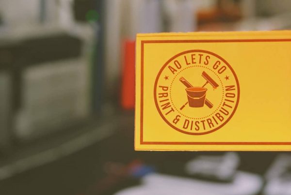 image of business card with A0 Lets Go logo on orange paper