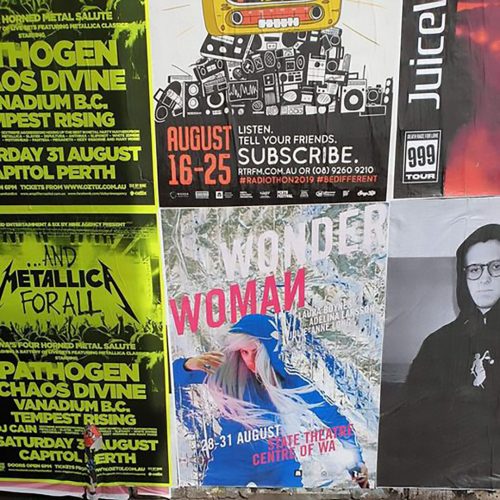 various street posters of events displayed on wall