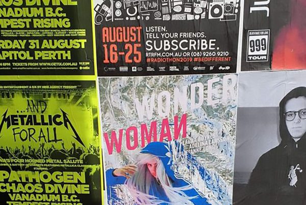 various street posters of events displayed on wall